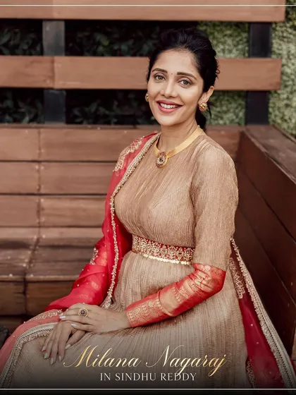 A seated portrait of Milana Nagaraj, showcasing the intricate details of the Anarkali's embroidered belt and Banarasi sleeves.