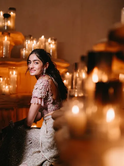 A bride bathed in the warm, flickering glow of countless candles. This intimate and romantic portrait is one of our signature styles.