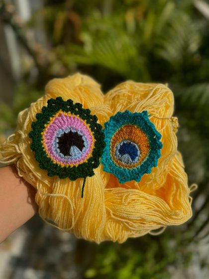 Our MorPankh (peacock feather) design, available as a keychain or a bookmark. The colors are so vibrant and beautiful.