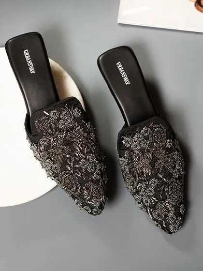 Step into something beautiful. These black embroidered mules are all about subtle elegance and a little shimmer, perfect for an evening out.