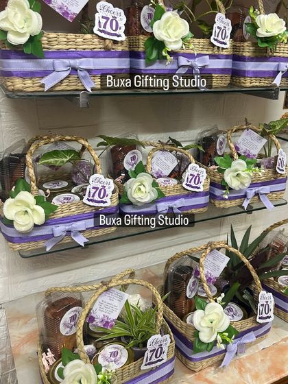 A display of the 70th birthday hampers on shelves, showing how I can create multiple, consistent gifts for a large party or family celebration.