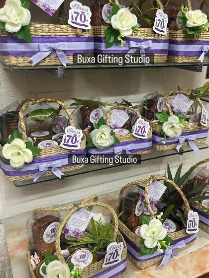 A full view of the 70th birthday hampers, showcasing the consistent and elegant mauve and white theme across the entire order.