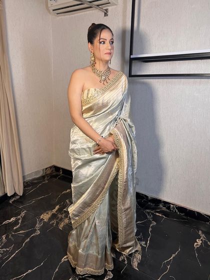 A full-length shot of the client in her elegant saree, looking absolutely stunning.