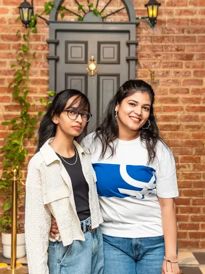 A great shot of friends enjoying the unique decor. The vintage carriage and brick wall make for an excellent photo opportunity.