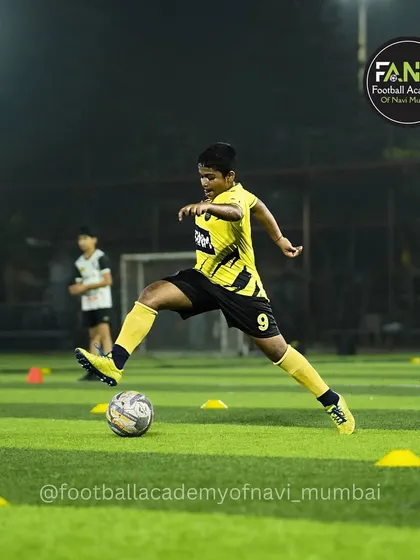 A player practices weaving through cones, a drill that builds precision dribbling skills.