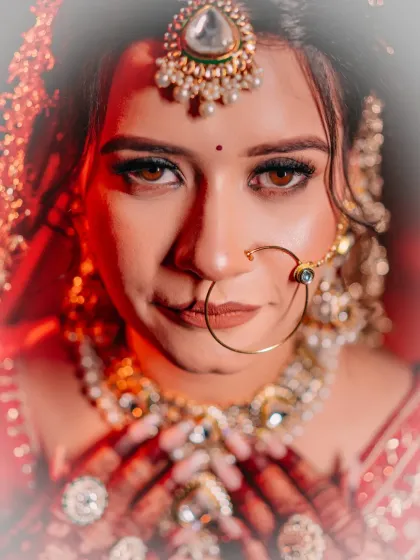 A bride's eyes tell a story of hope, love, and anticipation. I love creating intense, artistic bridal portraits like this one, using dramatic lighting to highlight the emotion and intricate details of the bridal jewellery and makeup.