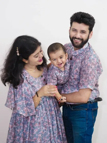 A coordinated family portrait session with matching outfits. This shows how a little planning on wardrobe can result in a beautifully cohesive and professional family photograph.