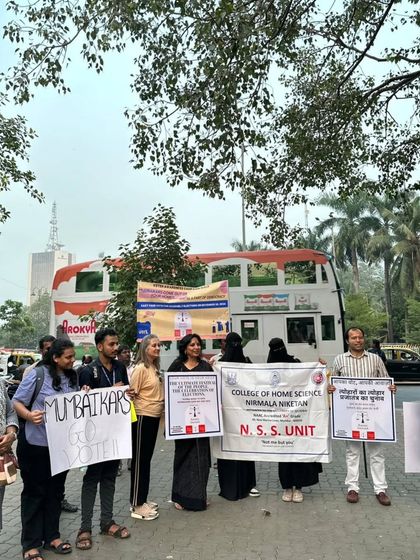 Our team, along with students from the College of Home Science's NSS unit, holding placards for our voter awareness drive. Collaboration with educational institutions is key to mobilizing the next generation of voters.