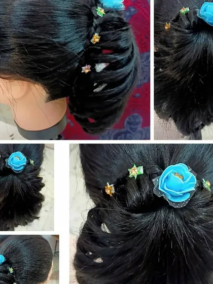 Another example of student practice on a mannequin. This stylish bun incorporates a side braid and is adorned with a blue flower, showing how students learn to integrate accessories into their hairstyles.
