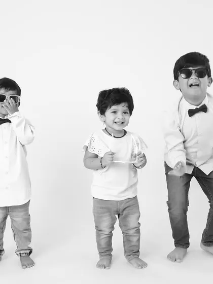 A fun black and white shot of three brothers dancing and laughing together in the studio. Their joy is absolutely infectious!