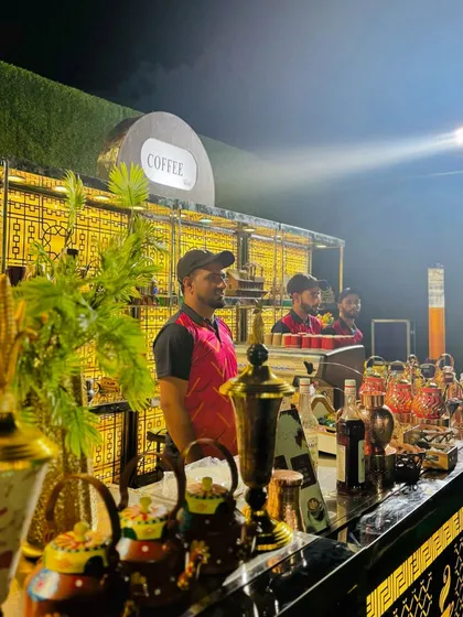 My beverage service extends to a full-fledged coffee bar. This setup features an espresso machine, a variety of syrups, and elegant copper teapots for a premium cafe experience at your event.