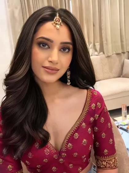 We are in love with these romantic curls. This soft, open hairstyle with a simple maang tikka is perfect for a pre-wedding pooja or a family gathering.