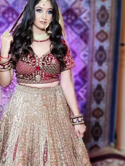 This is a classic Marwari lehenga with a red velvet blouse and a heavily embroidered gold skirt. It's a traditional and regal option for your wedding day.