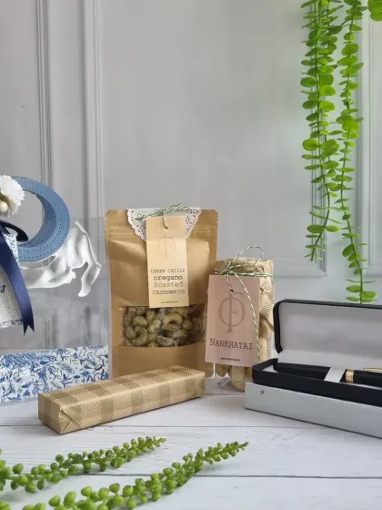 This corporate gift set combines a premium pen with our gourmet snacks like Namakpara and Green Chilli Oregano Roasted Cashews, presented in a "Best Wishes" bag.
