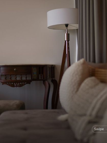 A cozy corner of the living room, with a floor lamp providing soft evening light. The focus is on creating a comfortable and intimate atmosphere for relaxation.