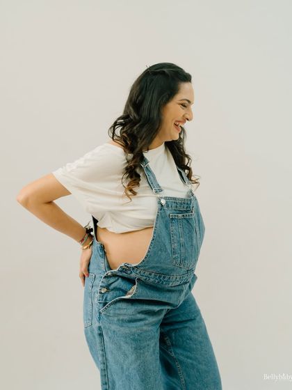 Rocking the denim dungarees! This fun and casual studio shot is perfect for the mom-to-be who wants something relaxed and playful.