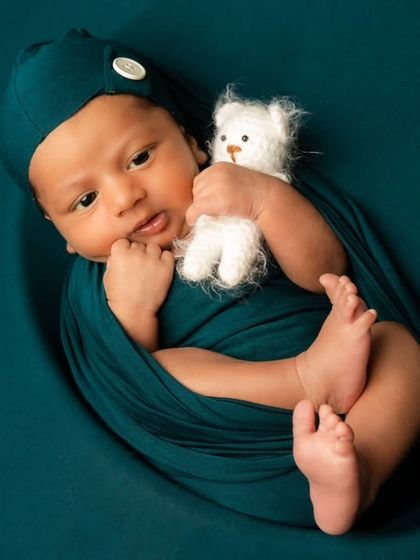 A slightly different angle shows this little one's tiny feet peeking out from the swaddle, a detail parents love to remember.