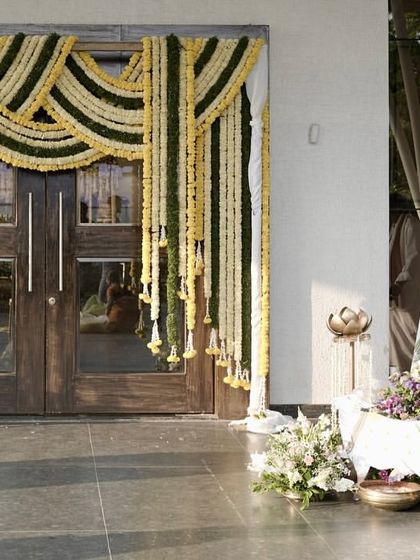 When tradition goes full luxe mode. This entrance to the wedding ceremony featured classic floral garlands and cow figurines, setting a sacred and welcoming tone from the very first step.