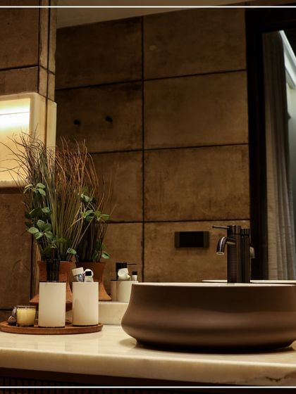 This bathroom detail shot highlights my focus on texture and natural elements. The stone-paneled wall, marble countertop, and earthy-toned basin create a calm, spa-like atmosphere.