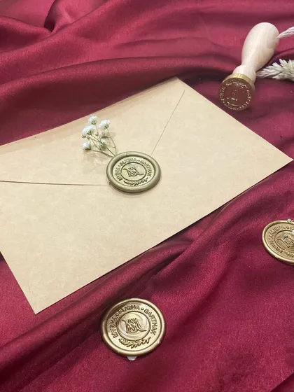 An envelope sealed with a custom monogrammed wax seal. It's the perfect way to elevate your wedding or event invitations.