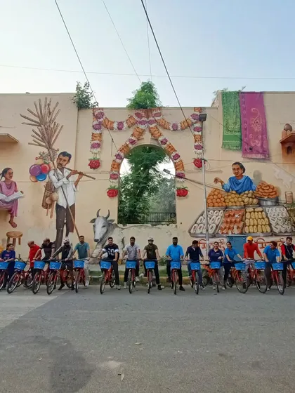 A group photo with our partners from KLM in front of a beautiful mural depicting scenes of Indian life. This is one of the most beloved artworks in the Lodhi district.