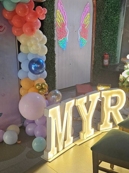 To personalize the mermaid theme, I added large marquee letters spelling out the birthday girl's name, 'MYRA'. These light-up letters make a big impact and look fantastic in photos.