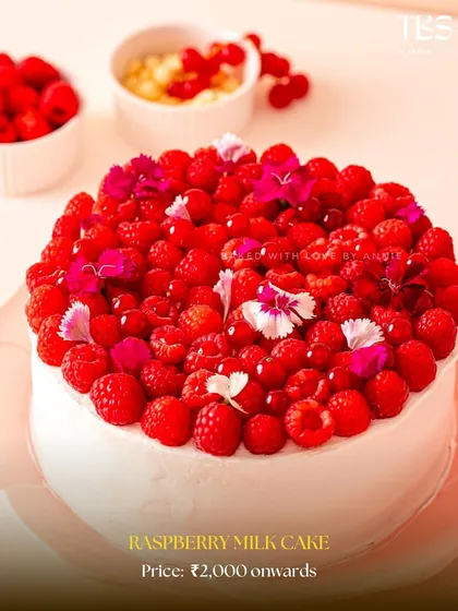 My Raspberry Milk Cake is a true beauty. It's topped with a mountain of fresh raspberries and delicate edible flowers, making it a stunning centerpiece.