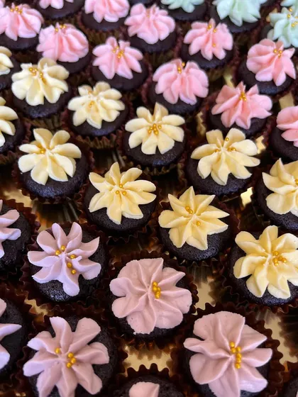 More of my handcrafted mini desserts for Louis Vuitton. These are mini Belgian chocolate cupcakes topped with pastel-colored buttercream flowers and gold sugar pearls.