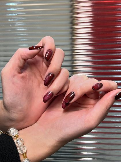 A closer look at the texture and shine of this deep red manicure. The subtle shimmer in the polish gives it a beautiful, multi-dimensional look.