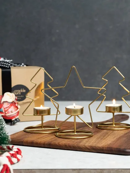 These wireframe tea light holders are a modern and minimalist way to decorate for the holidays. This set includes two Christmas trees and a star, all in a beautiful gold finish.