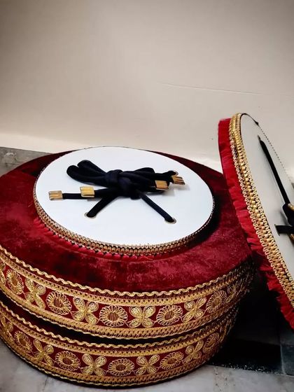 A professional pair of lightweight tabla rings in a rich red velvet with golden embroidery. These are designed to be both functional and visually appealing for any performance.