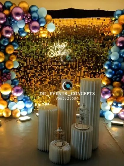 Another perspective of the gold shimmer wall birthday setup, showcasing the vibrant metallic balloon arrangement that frames the photo corner.