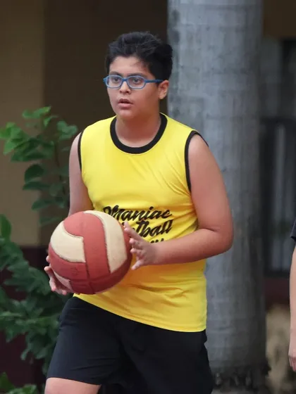 A young player holds the ball, focused and ready. This is the look of a player who is learning to think the game.