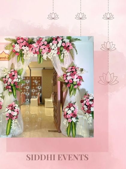 A simple yet beautiful entrance arch made of pink and white florals, creating a classic and romantic welcome for guests.