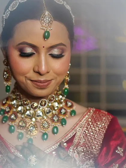 A soft, dreamy close-up of the bride, her smile gentle and her makeup glowing.