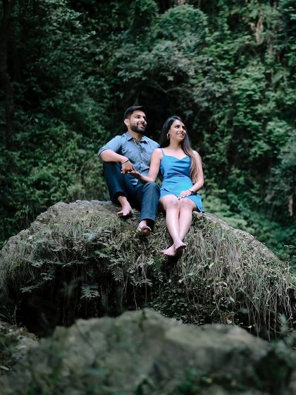 A relaxed moment from the Shimla pre-wedding shoot, with the couple sitting on a mossy rock. These are the natural, unposed shots that truly capture a couple's personality.