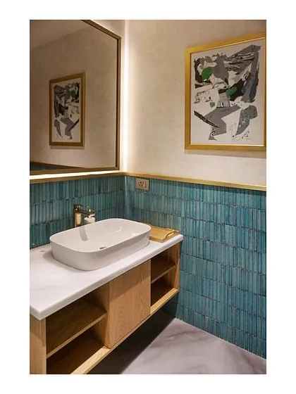 The bathroom in the Arrival Lounge at Bangalore airport. We used a vibrant green ceramic tile as a highlighter against a neutral wallpaper backdrop, creating a fresh and unique design for the washroom facilities.