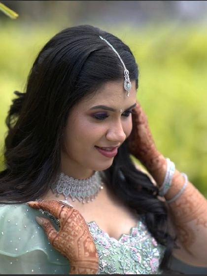 A close-up on her happy expression, her makeup looking fresh and pretty.