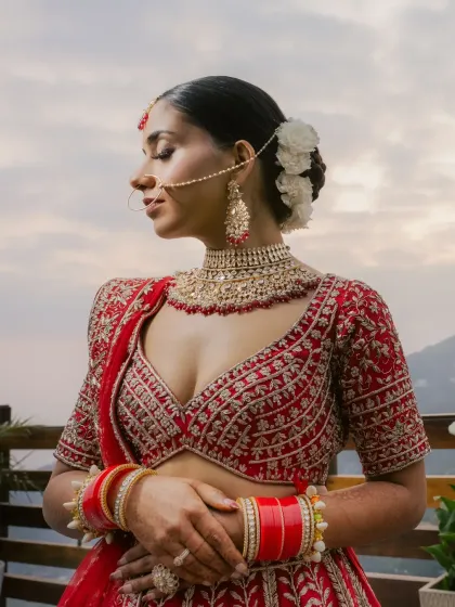 A serene bridal portrait against the backdrop of the Mussoorie hills. The bride's calm expression and elegant posture reflect a moment of peaceful contemplation.