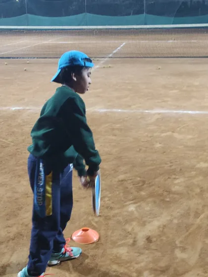 A young player focuses intently during a drill. We use cones and other training aids to improve footwork, positioning, and shot accuracy for our junior athletes.