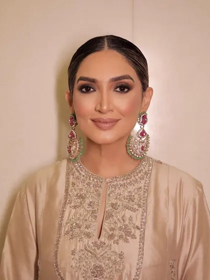A portrait focusing on the sharp, smokey eye makeup and the flawless base.