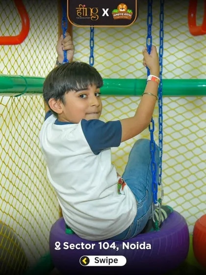 A boy tests his strength and coordination on the tire swing, part of our indoor ninja course. This area is designed for older kids looking for a bit more of a challenge.