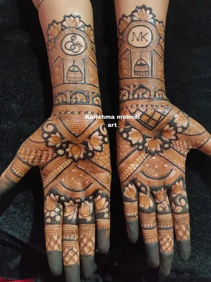 Personalization is key for modern bridal work. This engagement design incorporates the couple's initials 'MK' and ring symbols, a technique I teach to help you offer custom henna art to your clients.