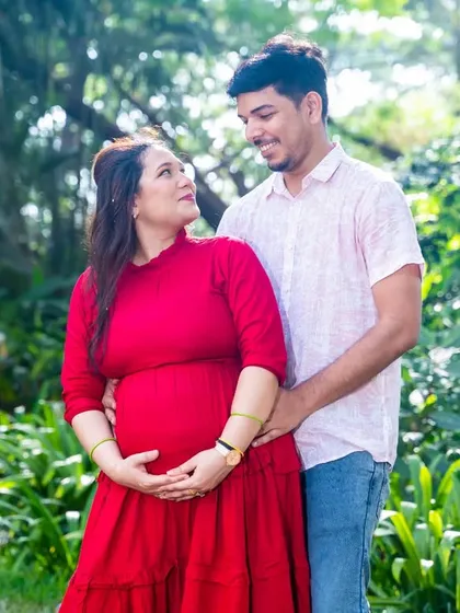A loving embrace in the garden. This couple shares a quiet, happy moment, surrounded by the beauty of nature.