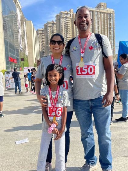 A family proudly wearing their medals after the 'Walk in My Shoes' event. We are so grateful for our amazing community who joined us to support this important cause.