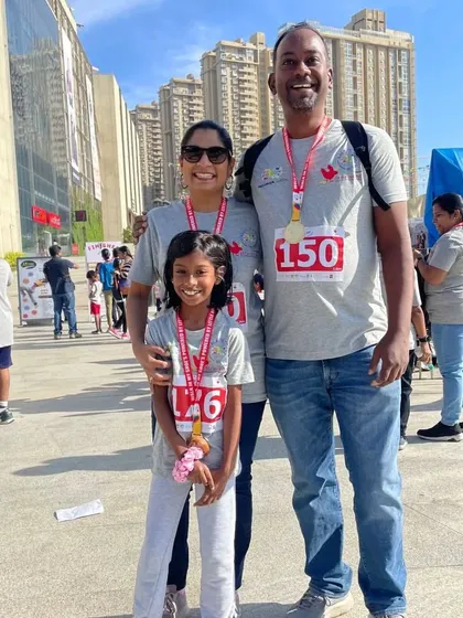 A family proudly wearing their medals after the 'Walk in My Shoes' event. We are so grateful to our community for joining us to share the important message of inclusion.