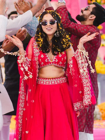 Having fun during the Haldi ceremony. The makeup is waterproof and designed to last through all the playful moments.