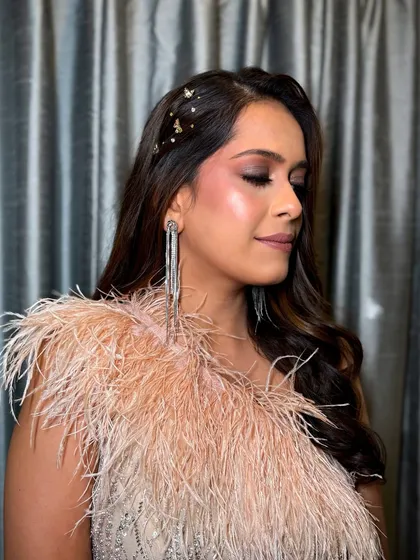 For a chic cocktail party, I went with a modern and glamorous look. The smokey eye, feathered dress, and sparkling hair accessories create a high-fashion statement perfect for an evening event.