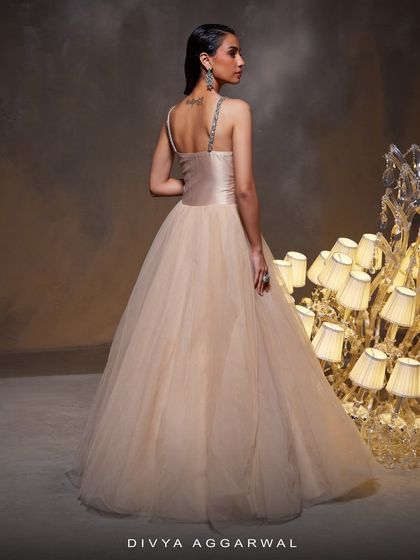 A view of the Bella Gown's stunning back profile. The design showcases the intricate corset detailing and the voluminous tulle skirt, creating a timeless and elegant silhouette.