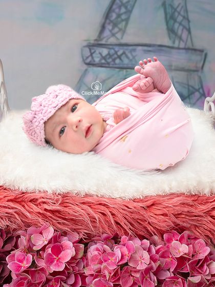 A little bit of Parisian charm for this baby girl. With the Eiffel Tower in the background and a bed of pink flowers, this is a truly romantic and sweet setup.
